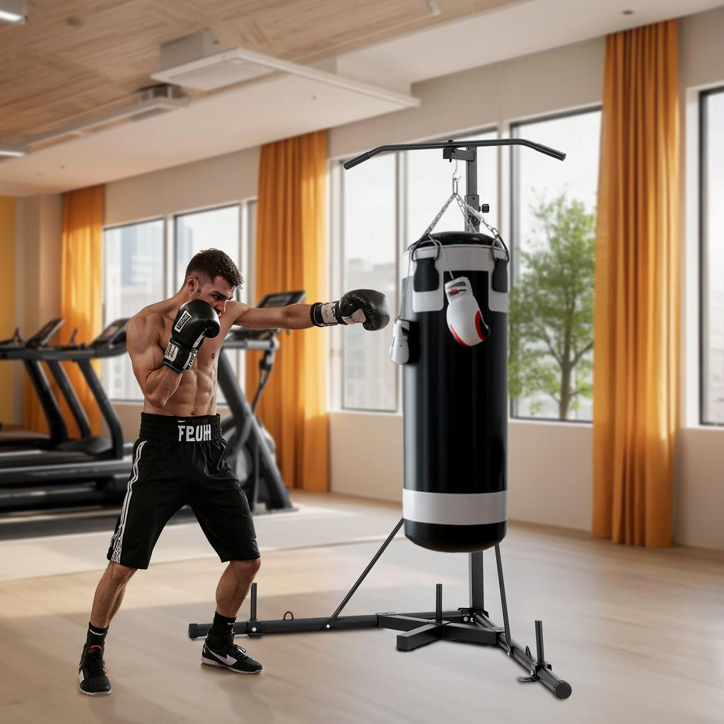 Man boxing a heavy bag on a freestanding steel 2-in-1 punching bag stand in a home gym with pull-up bar.